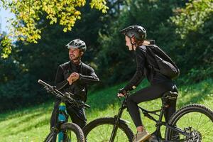A sweet couple, equipped with bicycles and engrossed in coordinating their journey, checks their GPS mobile and watches while planning scenic routes in the park, seamlessly blending technology and photo