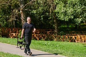 After completing a cinematic venture, a skilled videographer, adorned with camera equipment, leisurely strolls through the park, capturing the essence of post-production satisfaction and creative photo