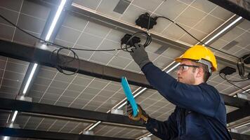 Engineer technical service checking solar panel while monitoring the system of solar panel on his tablet to make sure that's it work properly photo