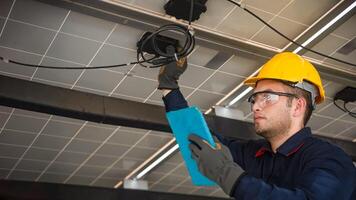 Engineer technical service checking solar panel while monitoring the system of solar panel on his tablet to make sure that's it work properly photo