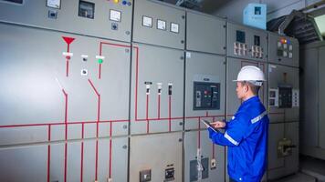 Electrical engineer check the operation of the main electrical control panel photo