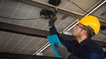 Engineer technical service checking solar panel while monitoring the system of solar panel on his tablet to make sure that's it work properly photo