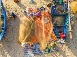 Top view of Fisherman casting his net at the sunrise or sunset. Traditional fishermen prepare the fishing net photo