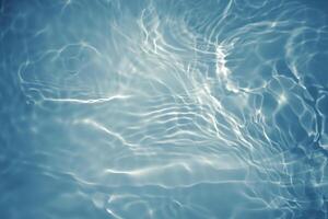 Blurred Blue Water Surface with Ripples and Bubbles photo
