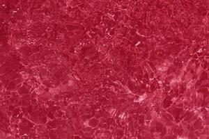 Close-Up of Calm Red Water Surface with Ripples and Reflections photo