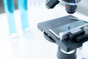 Scientist analyze biochemical samples in advanced scientific laboratory. Medical professional use microscope look microbiological developmental of viral. Biotechnology research in science lab. photo