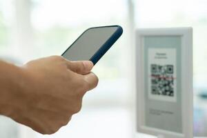 Woman use smartphone to scan QR code to pay in cafe restaurant with a digital payment without cash. Choose menu and order accumulate discount. E wallet, technology, pay online, credit card, bank app. photo