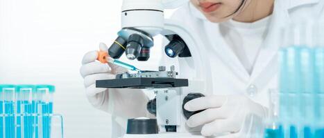 Scientist analyze biochemical samples in advanced scientific laboratory. Medical professional use microscope look microbiological developmental of viral. Biotechnology research in science lab. photo