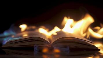 An open book against the backdrop of fire. Bonfire conflagration in slow motion in the dark. Book Burning - Censorship Concept video