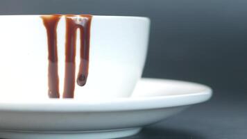 A cup with a drizzle of chocolate on it video