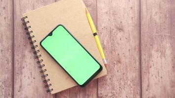 Smartphone and notebook on wooden table video