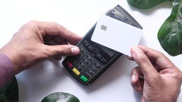 A man using a credit card to pay for a purchase video