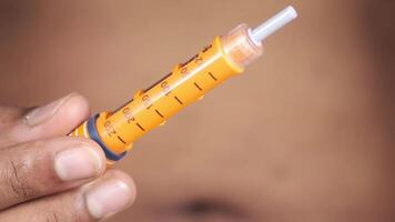 A person holding an injection in their hand video
