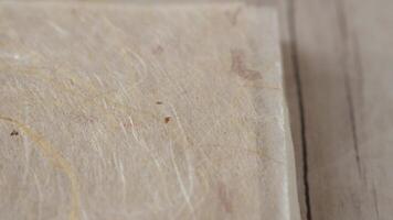 A close up of a piece of paper with a piece of wood video