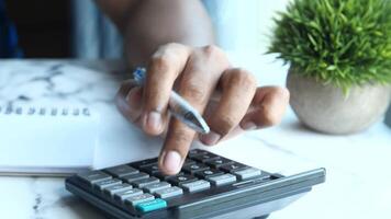 A person using a calculator on a desk video