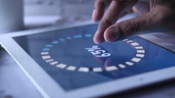 A person using a tablet with a clock on it video