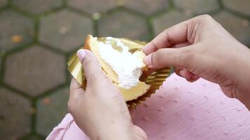 A person holding a piece of cake with frosting video