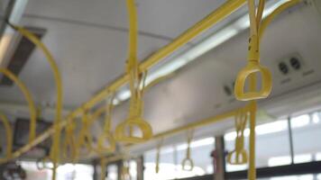 A row of yellow handle on a bus video