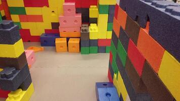 A room with many colorful blocks and a wall video