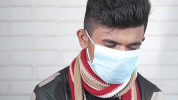 A man wearing a face mask and scarf video