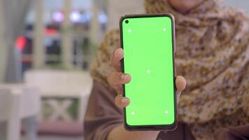 The Smartphone is Displaying a Green Screen for Various Digital Content Creation Needs video
