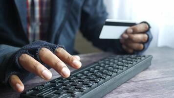 A person is typing on a keyboard with a credit card video