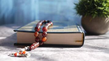 A book with a rosary on top of it video