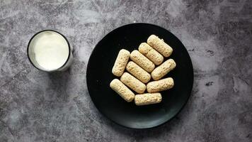A plate with some cookies and milk on it video