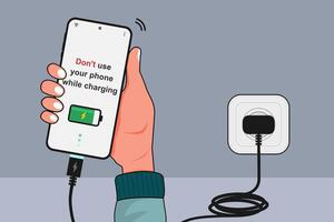 Do not use your phone while charging concept. Hand holding a mobile phone while charging. Electronic equipment safety campaign. vector