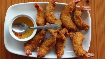 Fried shrimp with dipping sauce on a white plate video