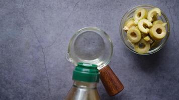 Olives in a bowl and a bottle of olive oil video