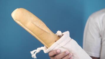 A man holding a baguette in his hand video