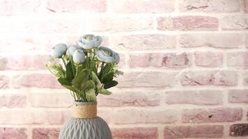 A vase with a blue flower on top of a table video