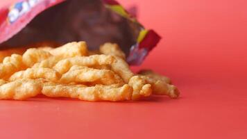 A bag of cheetos on a red background video