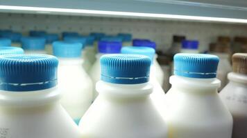 A row of milk bottles in a refrigerator video