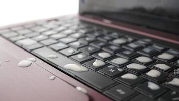 A close up of a laptop keyboard with a splash of water video