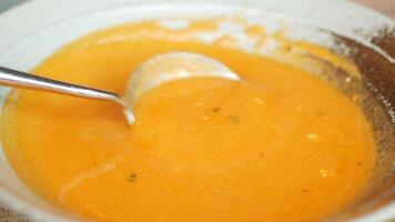 A bowl of soup with a spoon in it video