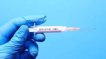 A person holding a syringe with the word stol video