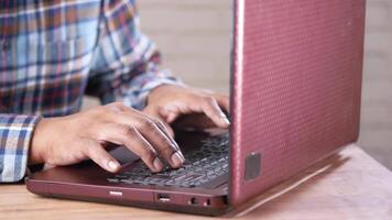 A man typing on a laptop computer video