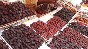 A man is standing in front of a table with lots of dates video