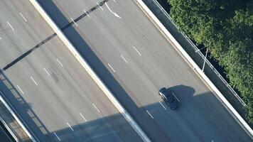 An aerial view of a car driving on a highway video
