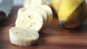 A banana sliced in half and a knife on a cutting board video