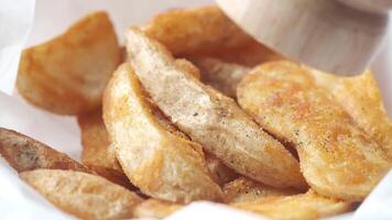 A basket of baked potatoes with a wooden spoon video