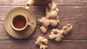 Ginger tea and ginger root on wooden table video