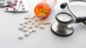 A stethoscope and pills on a white surface video