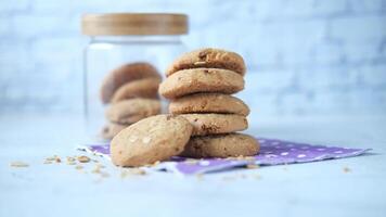 A stack of cookies next to a jar of peanut butter video