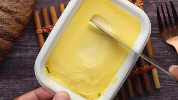 A person holding a spoon with butter in a container video