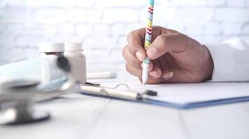 A person writing on a piece of paper with a pen video