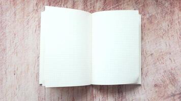 An open notebook on a wooden table video