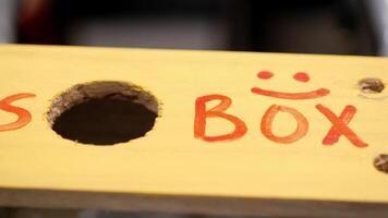A yellow box with the word so box written on it video